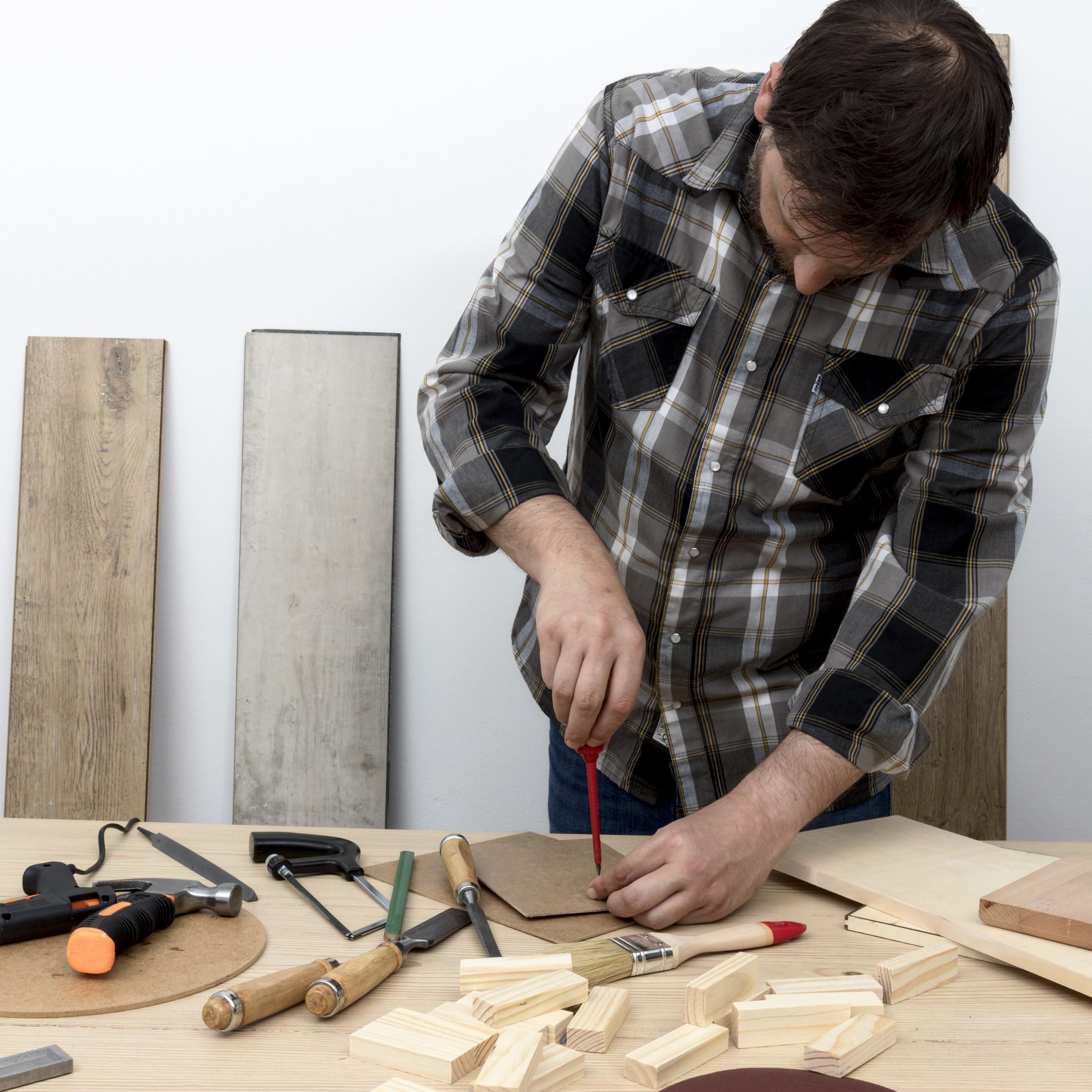 front-view-man-taking-measures-carpentry-workshop-concept